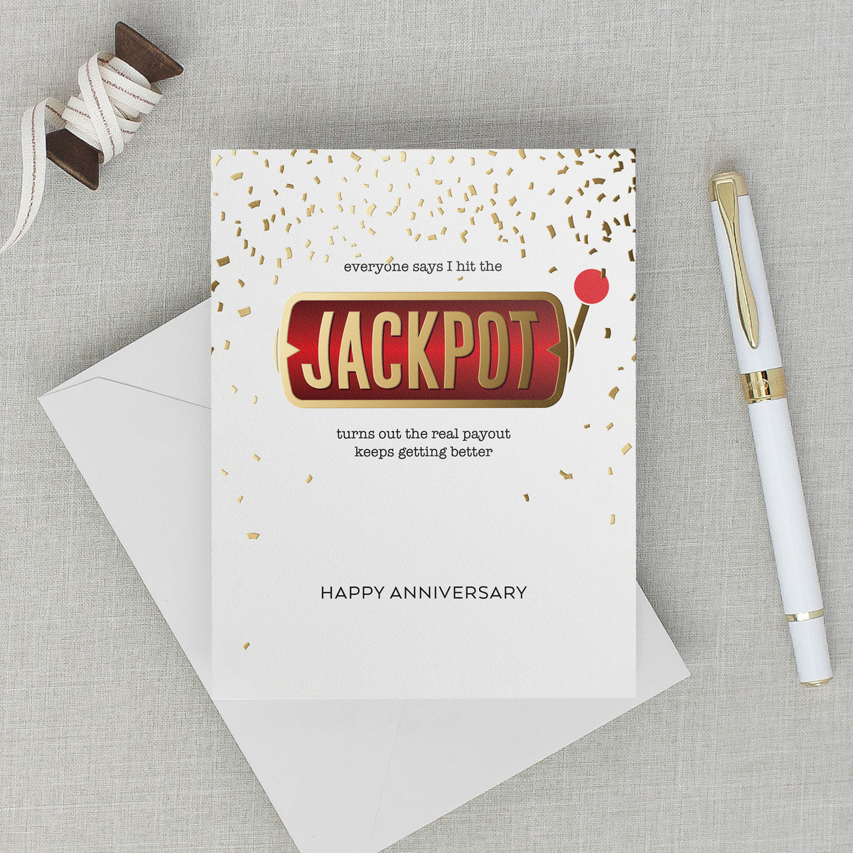Lifestyle photos with anniversary card featuring a slot machine handle and confetti that reads "everyone says I hit the JACKPOT turns out the real payout keeps getting better" HAPPY ANNIVERSARY