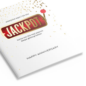 Three quarter view of anniversary card featuring a slot machine handle and confetti that reads "everyone says I hit the JACKPOT turns out the real payout keeps getting better" HAPPY ANNIVERSARY
