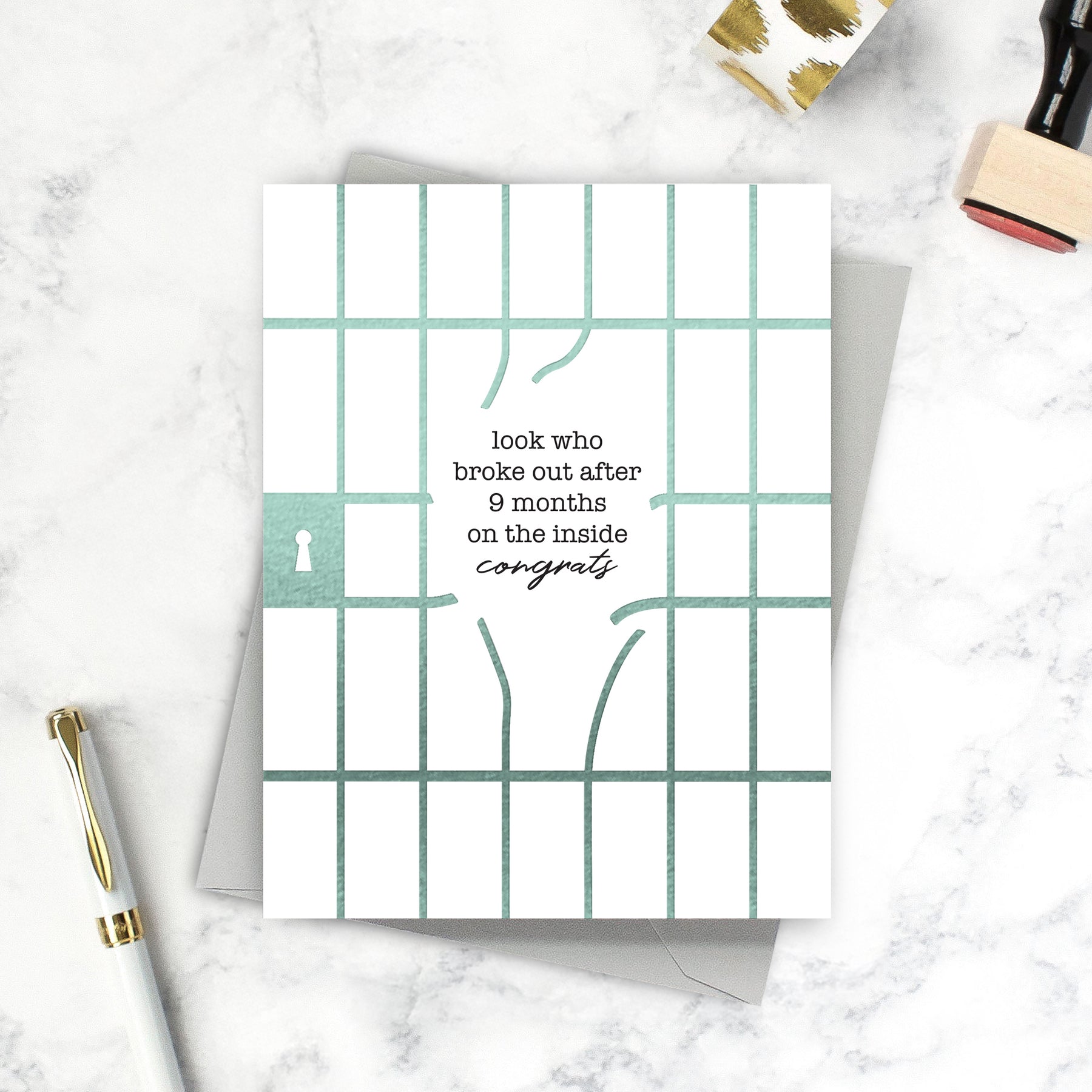 Greeting card with text and grid design on a marble surface