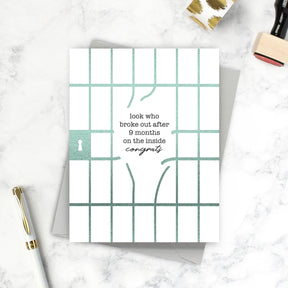 Greeting card with text and grid design on a marble surface