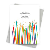 Greeting card with colorful candles and humorous text on a white background