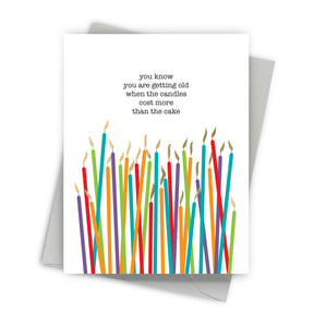 Greeting card with colorful candles and humorous text on a white background