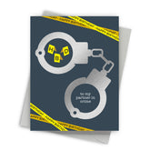 Greeting card with handcuffs and 'Happy Birthday' text on a blue background