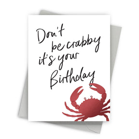 Greeting card with red crab and text 'Don't be crabby it's your birthday' on a white background