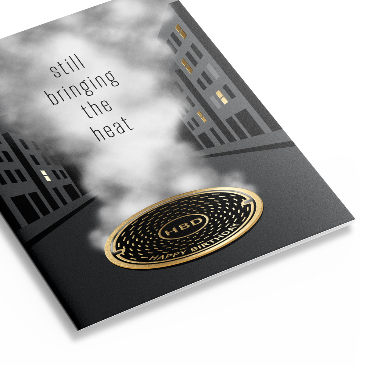 Three quarter view of urban themed birthday card that reads "still bringing the heat – Happy Birthday"
