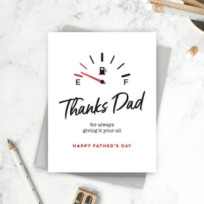 Father's Day card with fuel gauge design on a marble surface