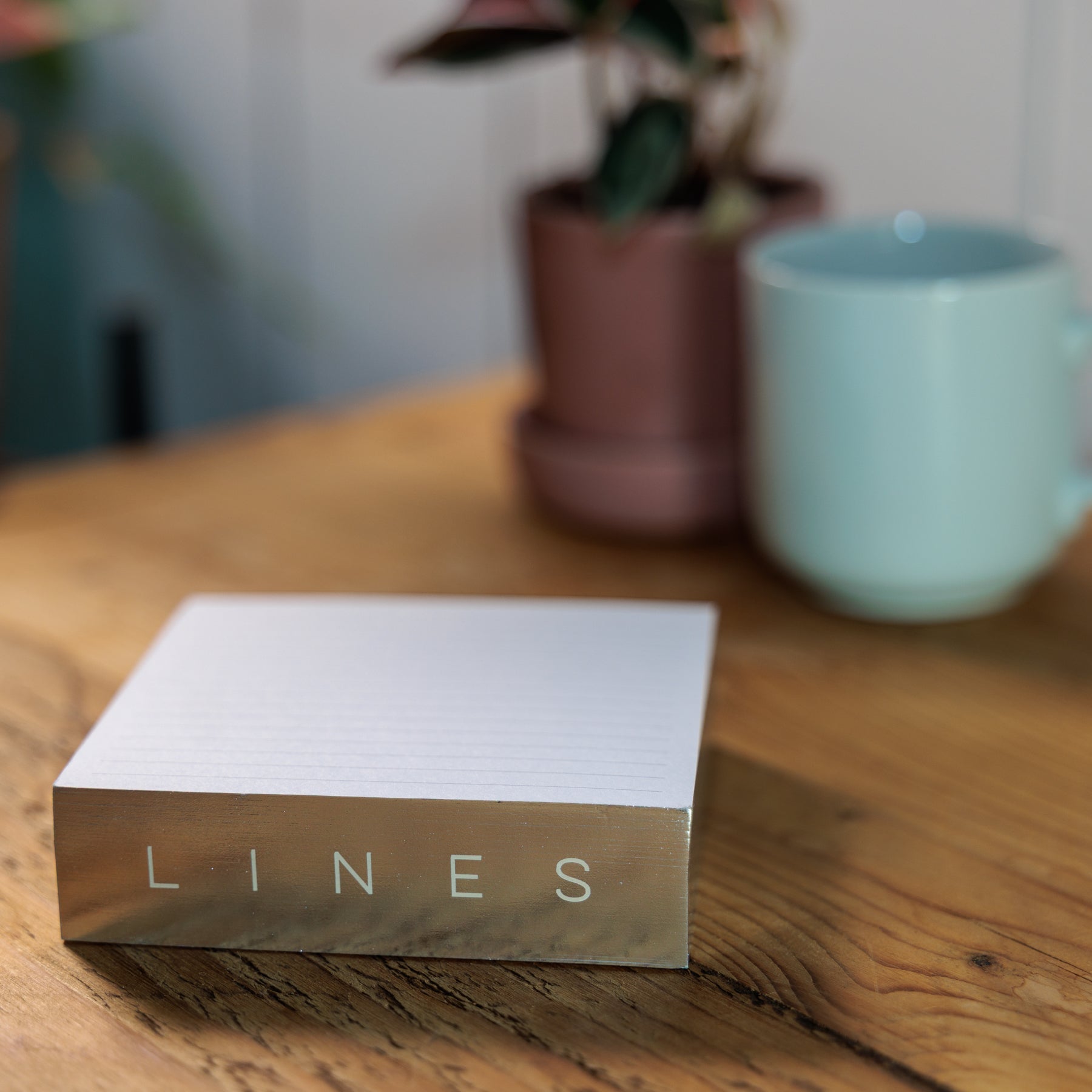 Silver Gilded Notepads on wood surface