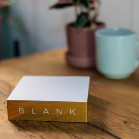 Gold Gilded Notepads on wood surface